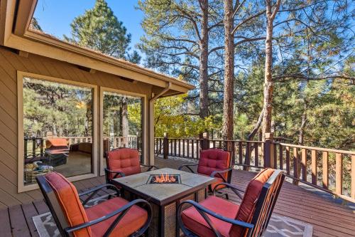 a deck with chairs and a table with a fireplace at Burning Tree in Flagstaff
