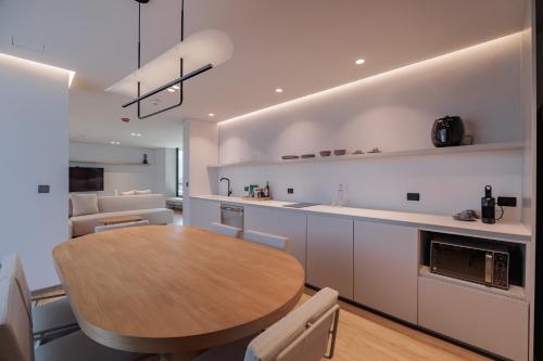 a kitchen and dining room with a wooden table at Seissta Medellín in Medellín