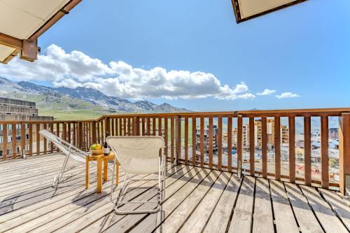 a deck with a table and chairs on it at Cozy Alpine Chalet with Ski-In access and Parking in Val Thorens 10 Niverolles in Val Thorens