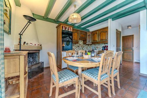 a kitchen with a table and chairs and a fireplace at Cozy Alpine Chalet with Ski-In access and Parking in Val Thorens 10 Niverolles in Val Thorens