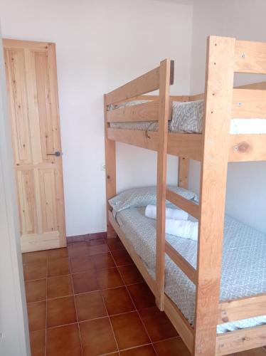 a room with two bunk beds in a room at Pis a primera línia de mar in L'Escala