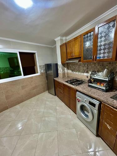 a kitchen with a washer and a dishwasher at Appartement luxe à tanger wifi gratuit in Tangier