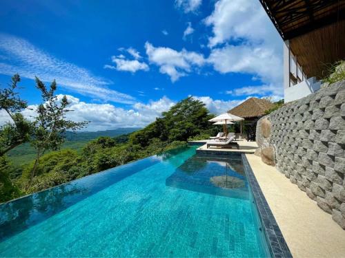 a pool at a villa with a view at Organica Yoga Shelter in Paquera