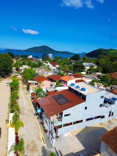 an aerial view of a town with a white building at Pousada Papito Ubatuba - Praia Perequê-Açu in Ubatuba