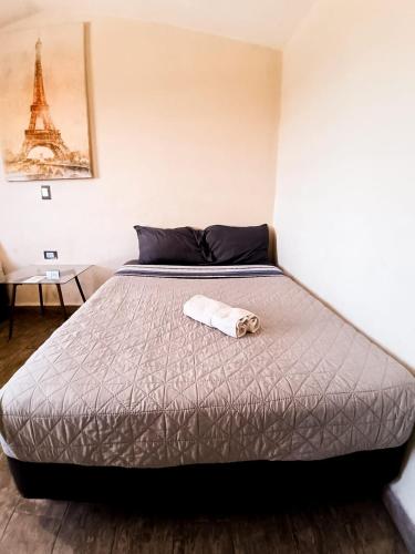 a bed in a room with a towel on it at Suite París, Paseo Durango in Durango