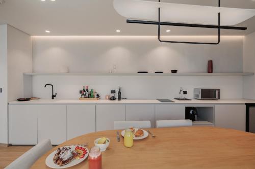 a kitchen with a table with plates of food on it at Seissta Medellín in Medellín