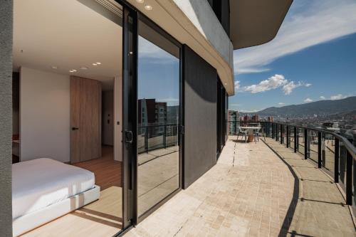 a bedroom with a bed on a balcony at Seissta Medellín in Medellín
