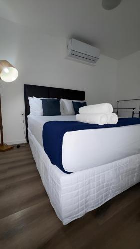a bedroom with a large white bed with towels on it at Apto de luxo, requinte e lazer no coração de Belém in Belém