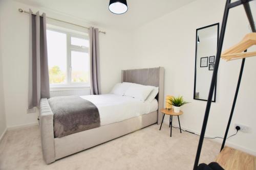 a white bedroom with a bed and a window at Spacious Central Oxford Detached Home in Oxford