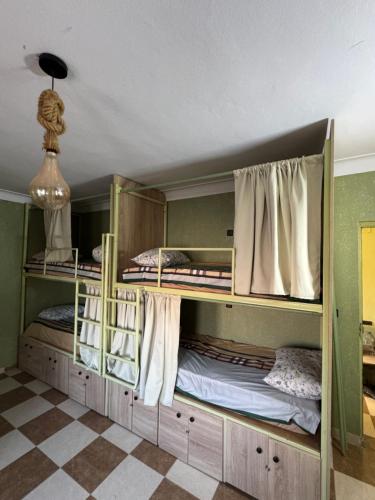 two bunk beds in a room with a checkered floor at Essaouira trip hostel in Essaouira