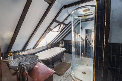 a bathroom with a tub and a sink and a bath tub at One Church Square in Rye