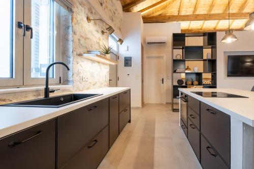 a kitchen with a sink and a counter top at Nest in the City Residence in Volos