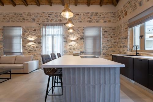a kitchen with a island and a living room at Nest in the City Residence in Volos