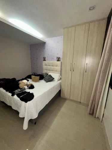 a bedroom with a bed and a large cabinet at Apartamento de Luxo in Belém