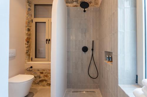 a bathroom with a shower with a toilet at Nest in the City Residence in Volos
