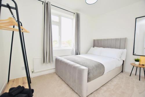 a white bedroom with a bed and a window at Spacious Central Oxford Detached Home in Oxford