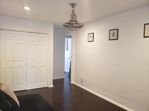 a room with white walls and a hallway with white doors at Downtown Allentown Stay in Allentown