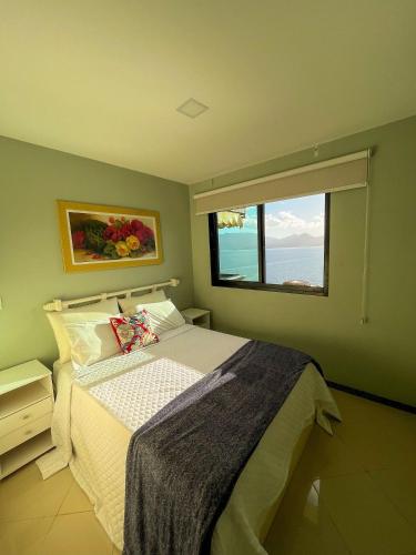 a bedroom with a bed and a large window at Porto Real Resort – Oportunidade de até 30% off + Vista Incrível do Mar! in Mangaratiba