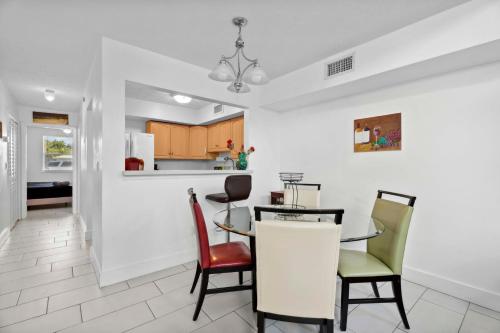 a kitchen and dining room with a table and chairs at Walk to Downtown - 3BR with Hot Tub & Games in St. Augustine