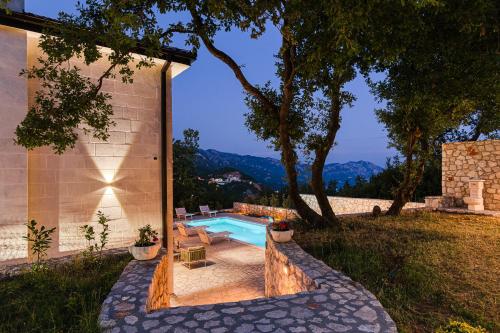 a swimming pool in the backyard of a house at Villa 53 in Lapčići