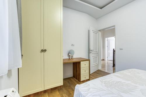 a bedroom with a desk and a bed and a closet at Villa 53 in Lapčići