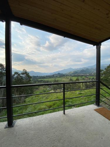 a view of a field from the porch of a building at Taikú Ecolodge in Pacho