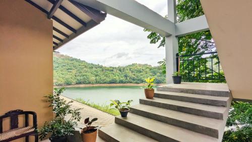 a view of a river from a house with stairs at Blue Waters Edge - Kandy in Kande
