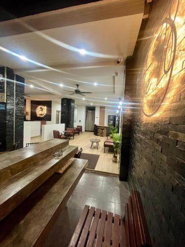 a lobby with wooden benches and a brick wall at 28 Boutique Hotel - Newly Renovated in Patong Beach