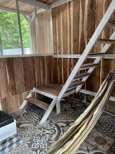a hammock in a room with a wooden wall at Jumanji in Palomino
