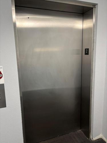 a metal elevator door with the number four on it at Baymont by Wyndham Kingdom City in Kingdom City
