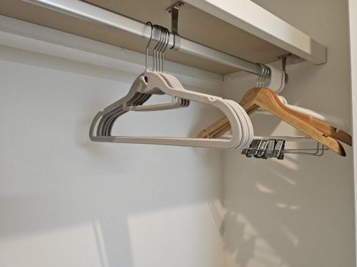 a pair of hangers hanging from a rod in a room at タスキsmart 錦糸町II in Tokyo