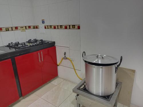 a kitchen with a stove and a large pot at casa blanca in Restrepo