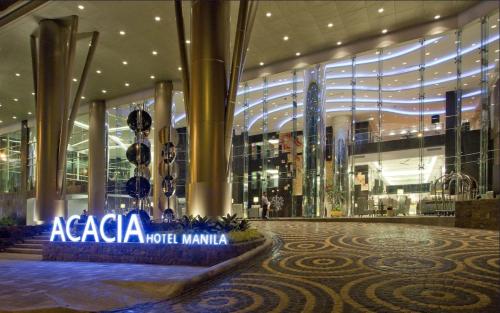 a shopping mall with a sign that says acaza more miami at Acacia Hotel Manila in Manila