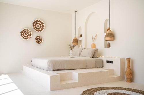 a white bedroom with a bed with white walls at Kasih 2 - Villa with private pool in Gili T in Mantaak