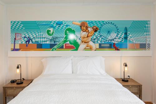 a bedroom with a mural of a baseball player at HomeField Inn in Sandusky