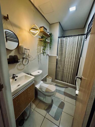 a bathroom with a toilet and a sink and a shower at Japandi Zen Victorias Secret Haven in Marilao