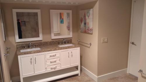 a bathroom with two sinks and a mirror at Spectacular View Just Steps to Pool and Jacuzzi at Sunrise Country Club in Rancho Mirage