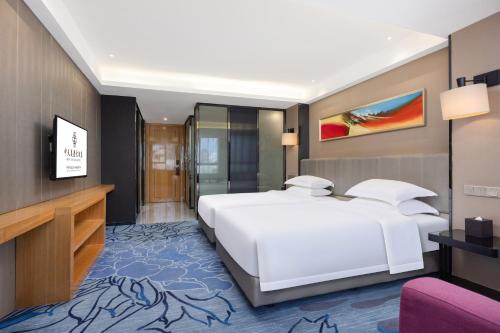 Ένα ή περισσότερα κρεβάτια σε δωμάτιο στο Zhongtian Mayfair Hotel - Bao'an International Airport Xixiang Subway Station