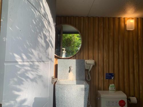 a bathroom with a sink and a mirror and a toilet at The X10 Nordic Tent and Glamping Pool Villa Khaoyai เขาใหญ่ - SHA Certified in Ban Thung Sawang