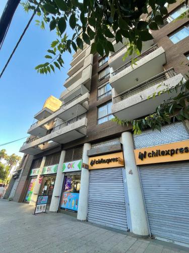 a building with two garage doors in front of it at Confortable departamento en Providencia in Santiago