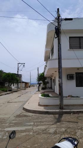 an empty street next to a white building at Caribe Tolú in Tolú