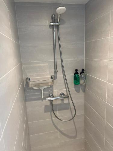 a shower with a shower head in a bathroom at Zandvoort Boutique Apartments in Zandvoort
