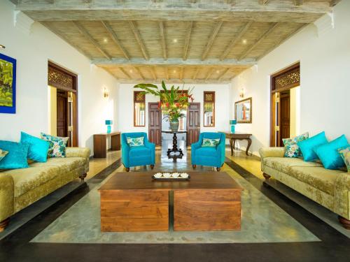 a living room with two couches and a coffee table at Villa 46 in Hikkaduwa