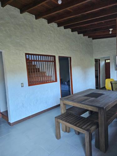 a wooden table and bench in a room at Don tranquilo in Alejandría