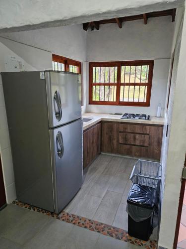 a kitchen with a stainless steel refrigerator and a window at Don tranquilo in Alejandría