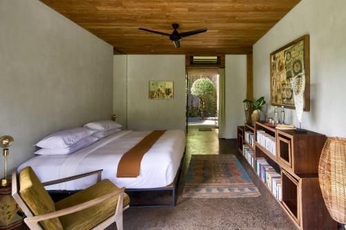 a bedroom with a bed and a ceiling fan at Chameleon Villa Bali in Tabanan