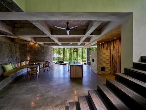 a large living room with a table and chairs at Chameleon Villa Bali in Tabanan