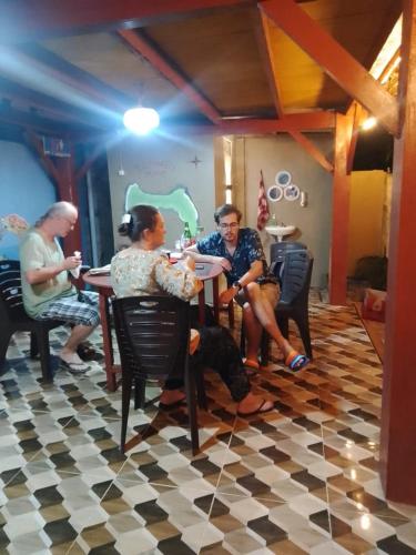 a group of people sitting at a table at Three Ken Homestay & Cafe in Manado