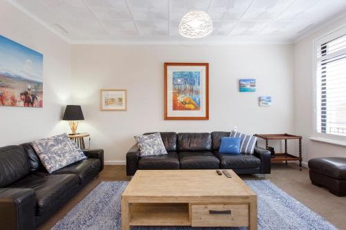 a living room with a couch and a coffee table at Living the Dream - 3 bedroom House South Fremantle in South Fremantle