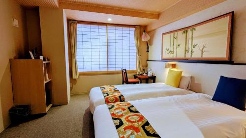 a hotel room with a bed and a window at Kyoto Inn Gion in Kyoto
